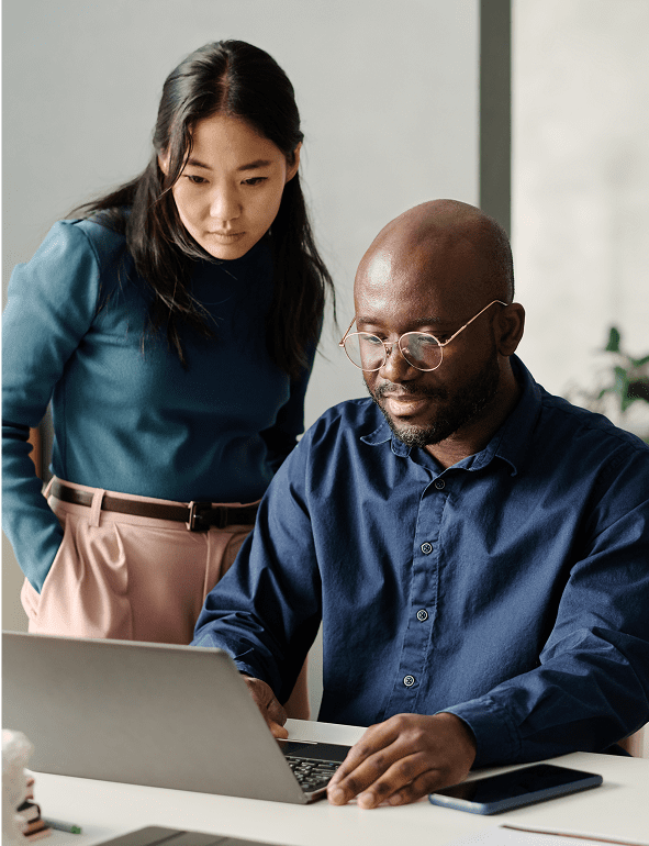 Two people collaborating on a laptop.